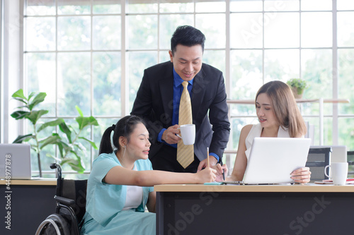 Young Asian disabled businesswoman working with colleague and her maneger,  meeting and consulting feeling happy, working together in the workplace photo