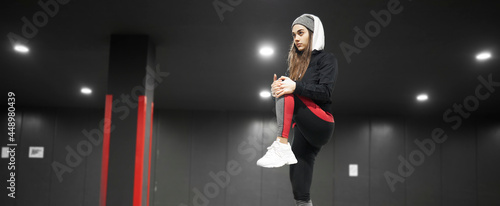 Young woman warming up before a midnight run