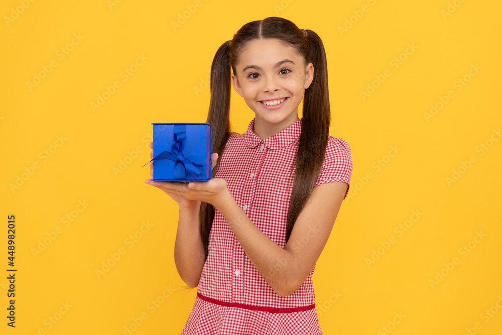 happy child hold present box on yellow background, holiday happy child hold present box on yellow background, holiday