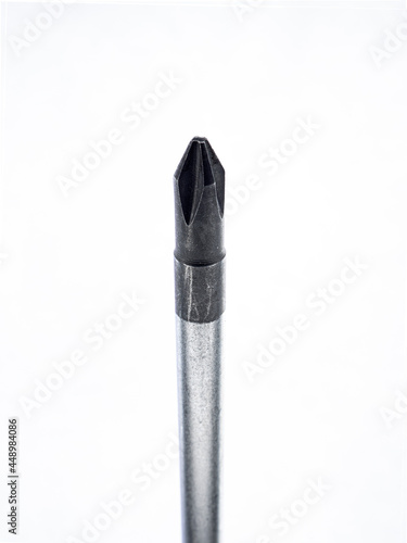 old screwdriver phillips head close up on white background. photo