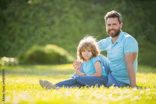 Wallpaper Mural happy family portrait of father and son boy relax in summer park green grass, family love Torontodigital.ca