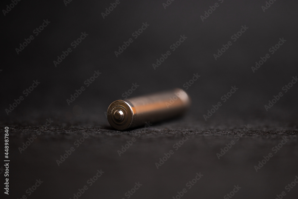 metal AAA battery on a black background metal AAA battery on a black background