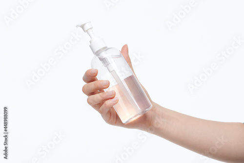 women hold alcohol bottle in hand on white background