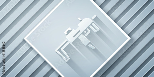 Paper cut MP9 submachine gun icon isolated on grey background. Automatic weapon. Paper art style. Vector