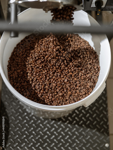 Plastic bucket with coffee beans under bean release chute