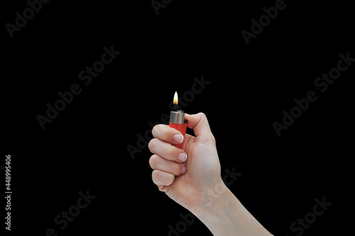 Hand with red lit lighter isolated on black background. Concept hands and fire