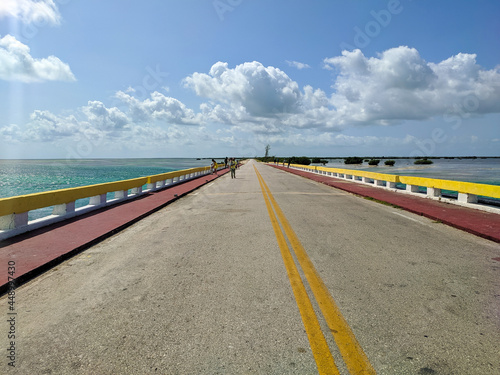 Cayo Coco, Cuba, 16 may 2021: Tourists cross the Hemingway Bridge on foot and admire the sea views. The Hemingway Bridge connects the Cuban islands of Cayo Coco and Cayo Guillermo. photo