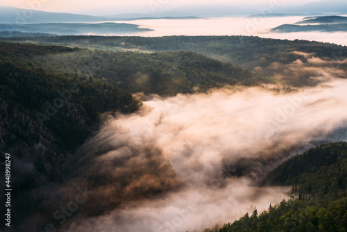 Fog in the mountains at sunrise. Morning fog in the mountains at dawn. Clouds in the mountains. Morning fog after rain. Mountains at dawn. Milk rivers. Copy space