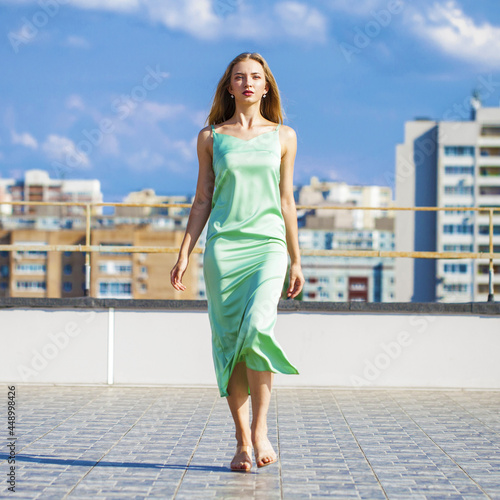 Young beautiful fashion woman walking on the roof