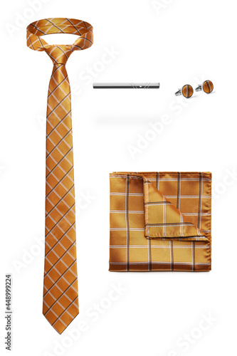 Subject shot of stylish set for office wear composed of yellow checkered tie, silk handkerchief to match, steel tieclip and cufflinks. Accessories for men are isolated on the white background. photo