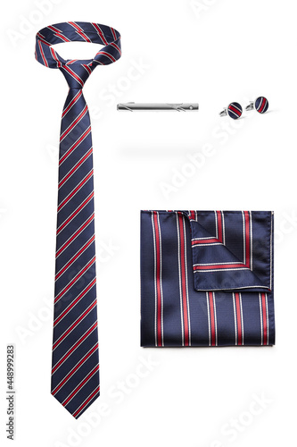 Subject shot of stylish set for office wear composed of striped tie, silk handkerchief to match, steel tieclip and cufflinks. Accessories for men are isolated on the white background. photo