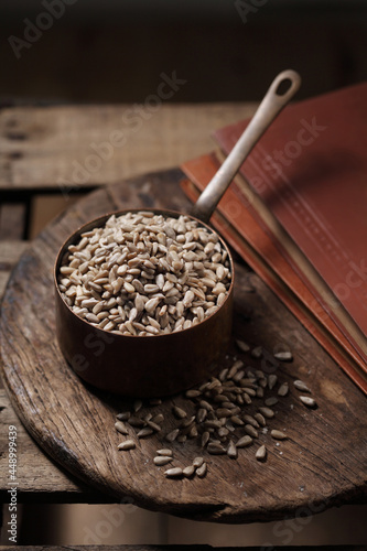 sunflower seeds in cup on the wooden background