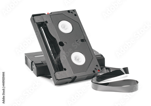 Two mini videotapes with unwound magnetic tape isolated on white.