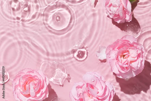 Obraz Top view of pink transparent clear calm water surface. Texture with splashes and bubbles and podium for cosmetics product. Trendy abstract summer nature cosmetic background