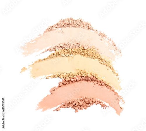 Swatches of different crushed face powders on white background  top view