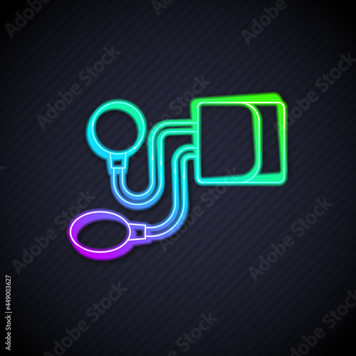 Glowing neon line Blood pressure icon isolated on black background. Vector