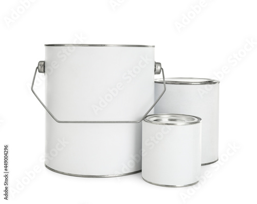 Closed blank cans of paint on white background photo