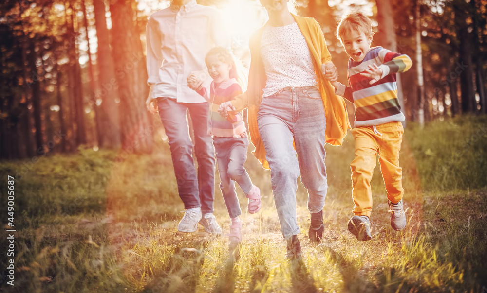 Fototapeta premium Happy family walking in the summer park