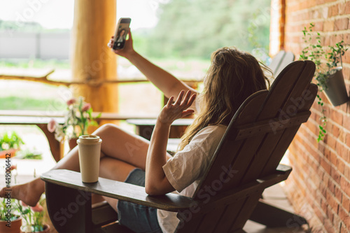 Young woman laughs and talking by video call on the phone. The concept of lifestyle mobility Free Download Young woman laughs and talking by video call on the phone. The concept of lifestyle mobility - GFXLoad