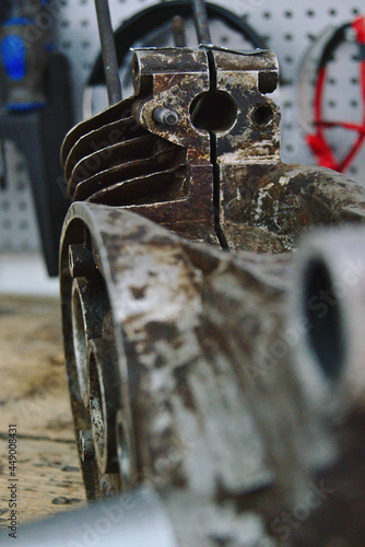 An old dirty simson moped motor on a workbench photo