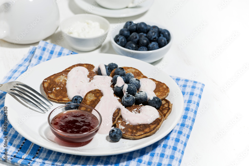 homemade pancakes with blueberries and jam for breakfast