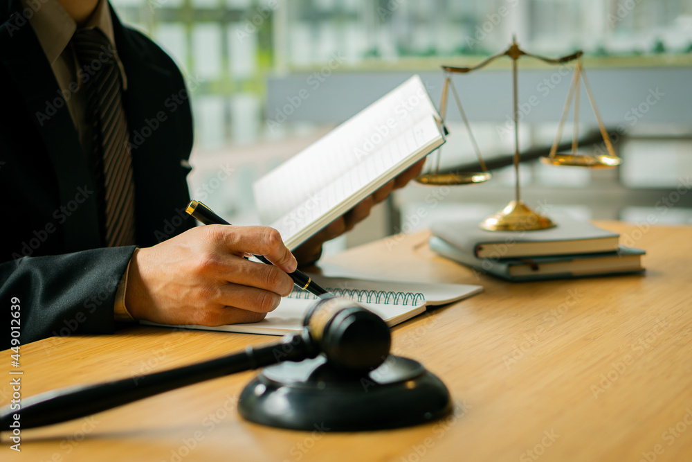 Male attorney advisor or judge advisor concept, having team meetings with clients, legal concepts and hammer attorneys with fair scales on desks in the office. Male attorney advisor or judge advisor concept, having team meetings with clients, legal concepts and hammer attorneys with fair scales on desks in the office.