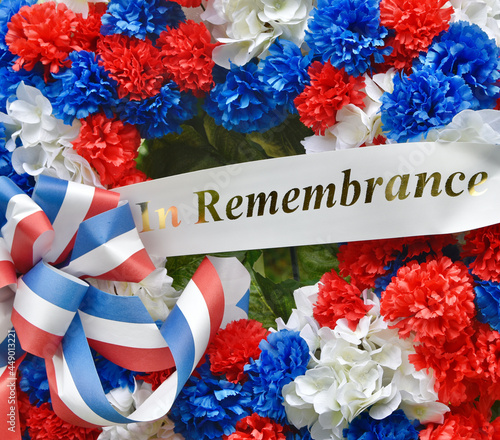 A Veterans memorial wreath with red, white, and blue silk flowers and an 