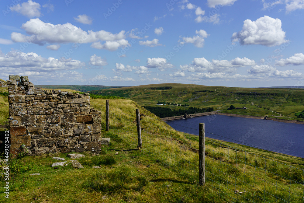 Remains of a small derilict buiding with Scar House Reservoir in the background, Nidderdale, North Yorkshire, England, UK.