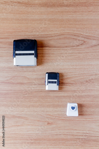 Wallpaper Mural Stamps isolated, and heart paper cutter on wooden background. Flat lay. Workspace. Torontodigital.ca