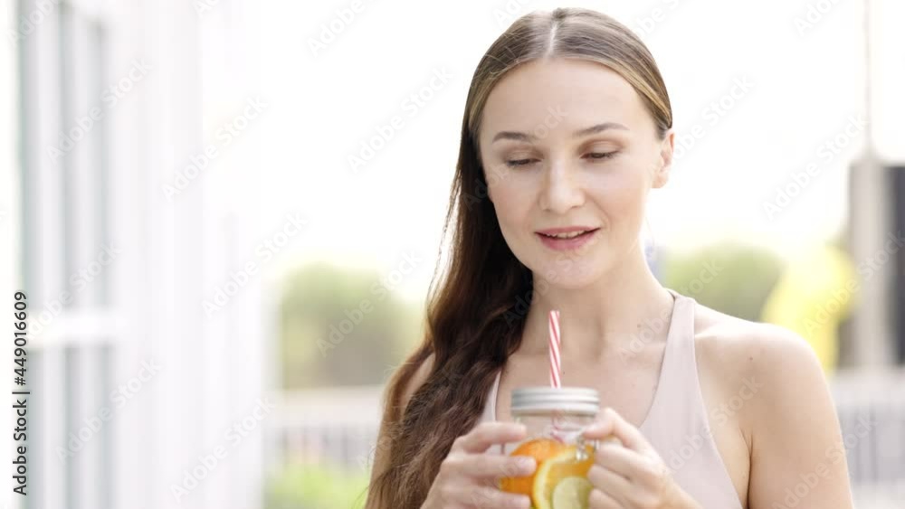 Beautiful caucasian woman feeling refresh and energetic drinking water Homemade orange lemonade soda with mint. beautiful woman face has natural freckles. Feel relaxed on weekend Beautiful caucasian woman feeling refresh and energetic drinking water Homemade orange lemonade soda with mint. beautiful woman face has natural freckles. Feel relaxed on weekend