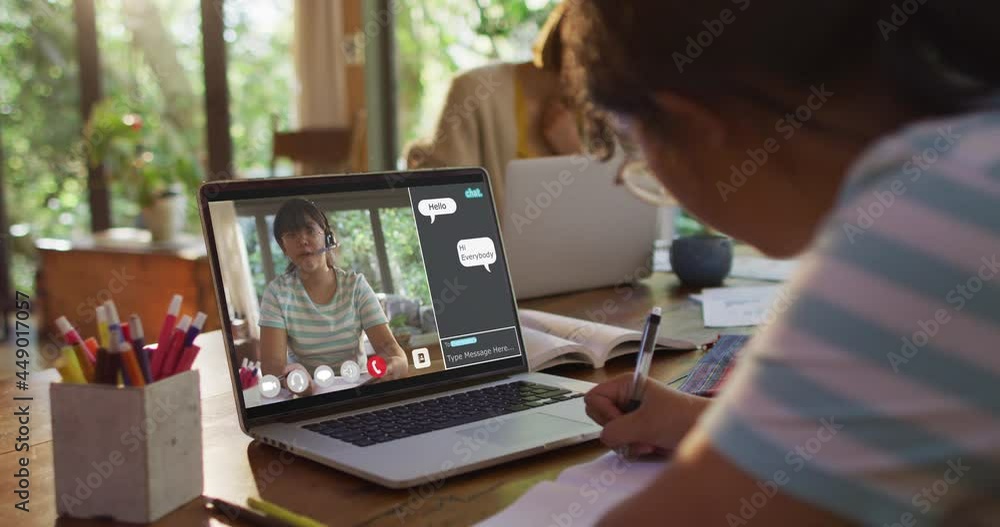African american girl doing homework and having a video call with ...