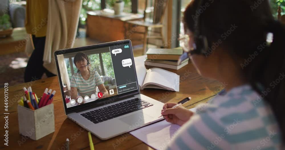 Girl doing homework and having a video call with female teacher on laptop at home Girl doing homework and having a video call with female teacher on laptop at home