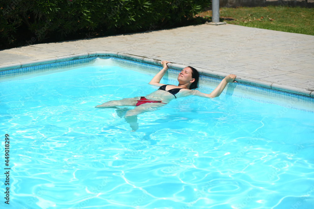 Portrait of a woman doing aquafitness in the outdoor swimming pool