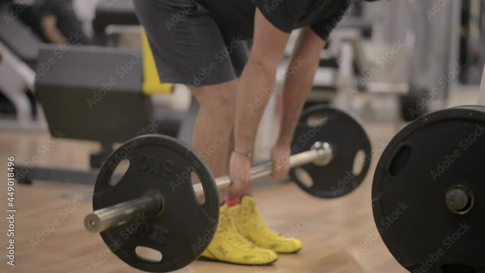 Closeup of the legs of person doing death-lifts Closeup of the legs of person doing death-lifts