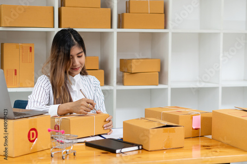Starting a Small Business, SME Owners, Female Entrepreneurs Have worked with boxes and laptops to check online orders to prepare the boxes. Selling to customers. Online SME business idea.