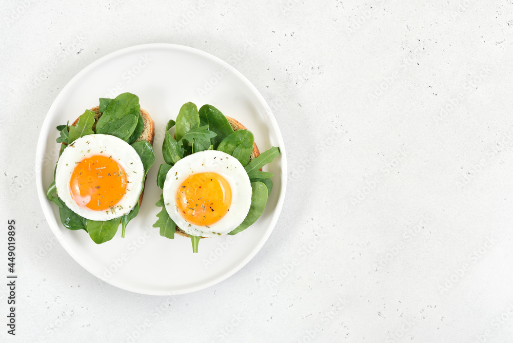 Fried eggs and greens on bread Fried eggs and greens on bread