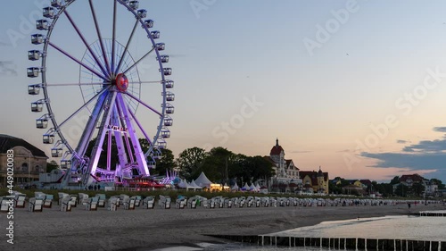 Time lapse: Promenade of Kuehlungsborn with a ferris wheel in the twilight , Germany	
