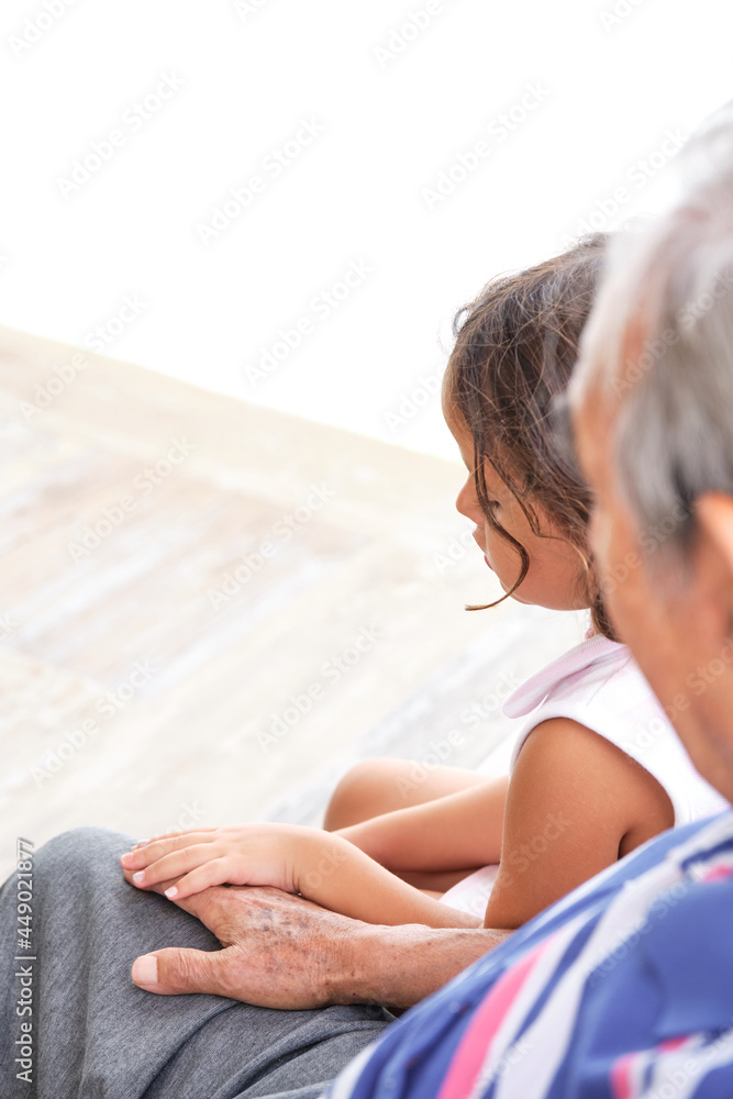 grandfather and granddaughter holding hands
