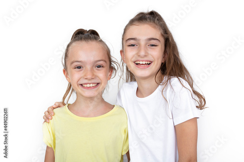 Happy little girls hugging each other