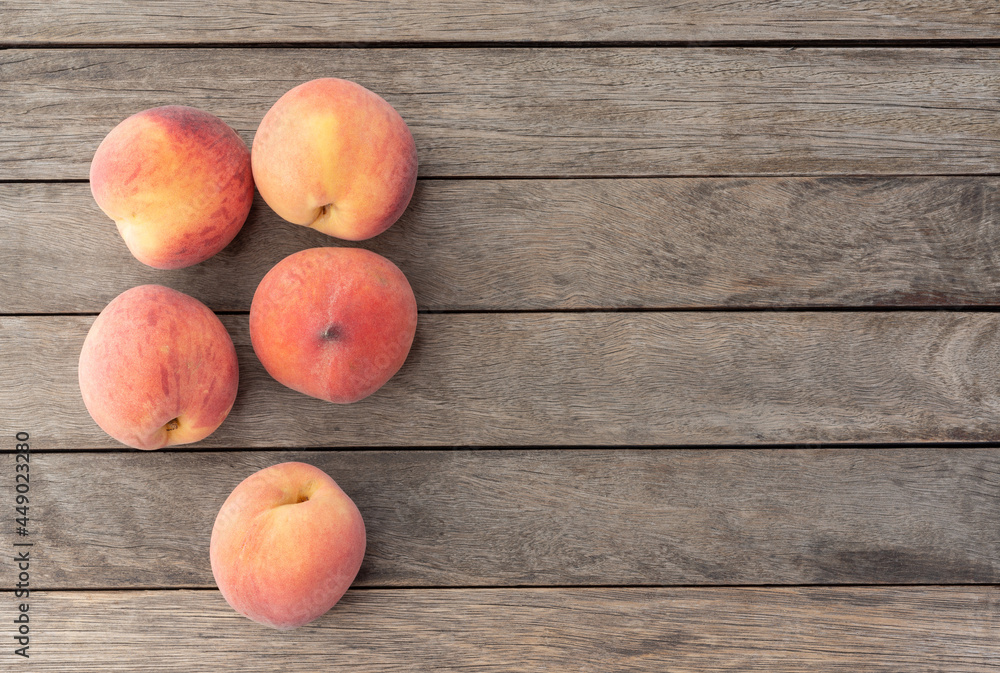 A group of peaches over wooden table with copy space A group of peaches over wooden table with copy space