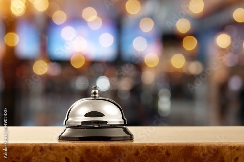 Vintage hotel reception service bell on the desk.