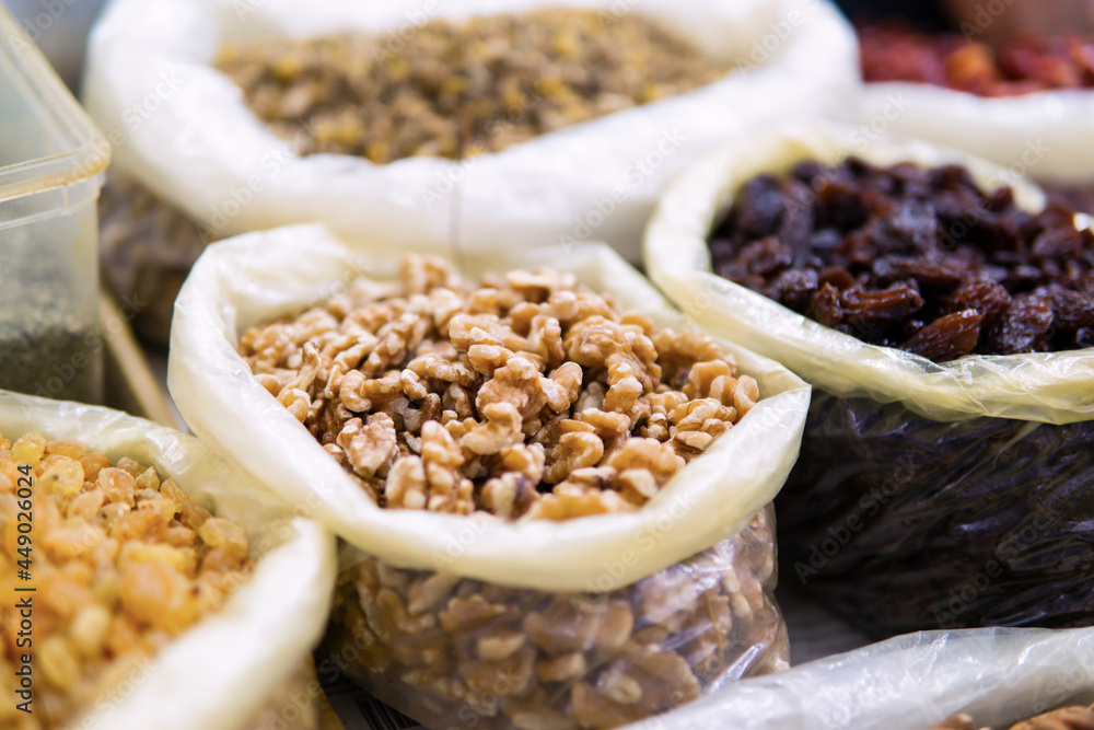 Close-up view of various dried fruits from Morocco on display at a traditional food market. Close-up of peeled nuts Close-up view of various dried fruits from Morocco on display at a traditional food market. Close-up of peeled nuts