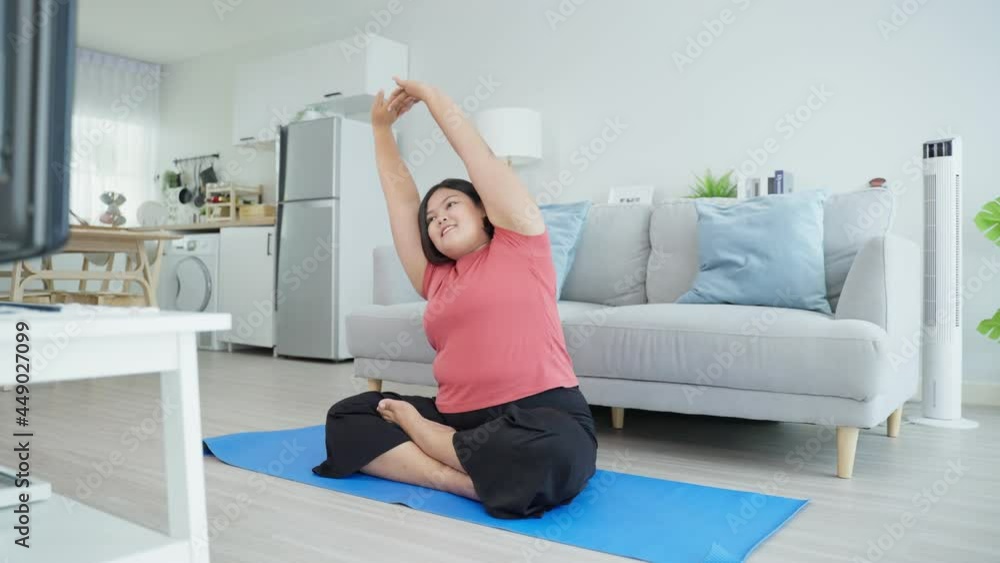 Asian young oversize woman doing yoga exercise in living room at home. Asian young oversize woman doing yoga exercise in living room at home.