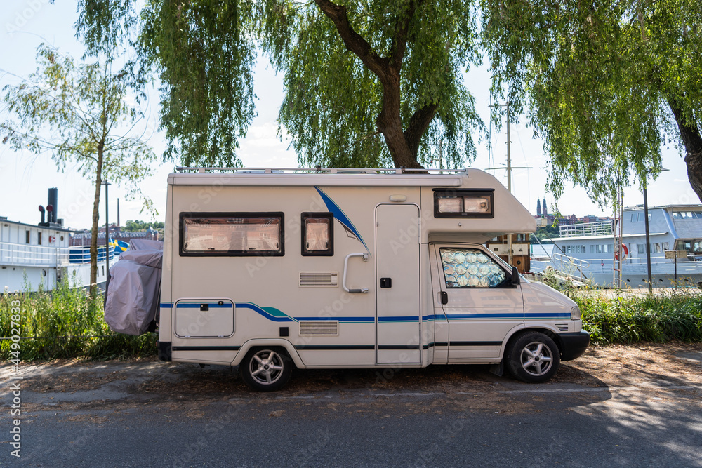 Caravan travel trailer RV motor home camper. Car vehicle journey. Tourism Summer vacation holidays activity trip to Europe. Mobile home on the seashore. House Life on wheels concept.