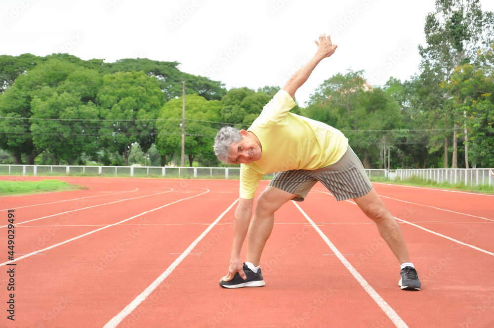 an old man warming up exercise before running or jogging, concept health care in elderly people
