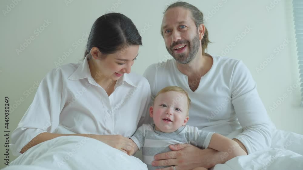 Portrait of Caucasian happy family smiling, look at camera in bedroom. Portrait of Caucasian happy family smiling, look at camera in bedroom.