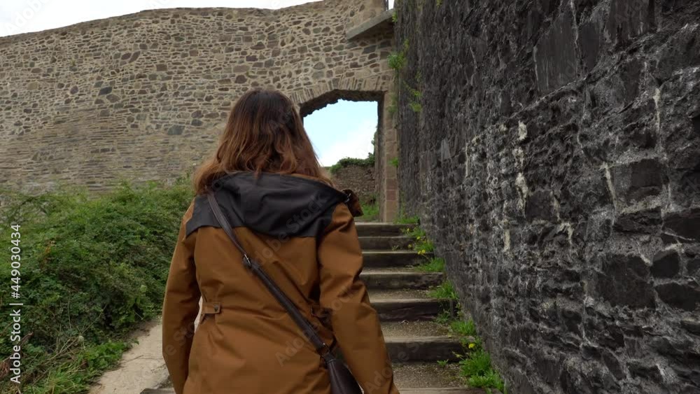 A young tourist visiting the castle of Fougeres. Brittany region, Ille et Vilaine department, France A young tourist visiting the castle of Fougeres. Brittany region, Ille et Vilaine department, France