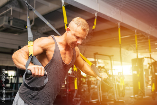 Muscular man working out in gym doing exercises,Exercise for triceps in the gym. strong male naked torso abs