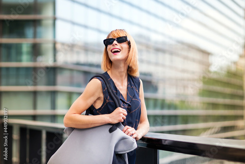 Vivacious trendy woman in modern sunglasses in a city