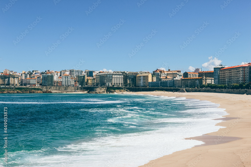 View of huge white waves of ocean laying on the main beach of A Coruña city